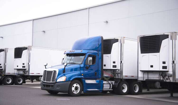 Blue tractor with reefer trailers
